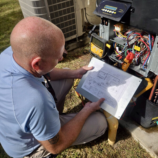 Davis Bros. Technician Reviewing Schematics for Pool Heater