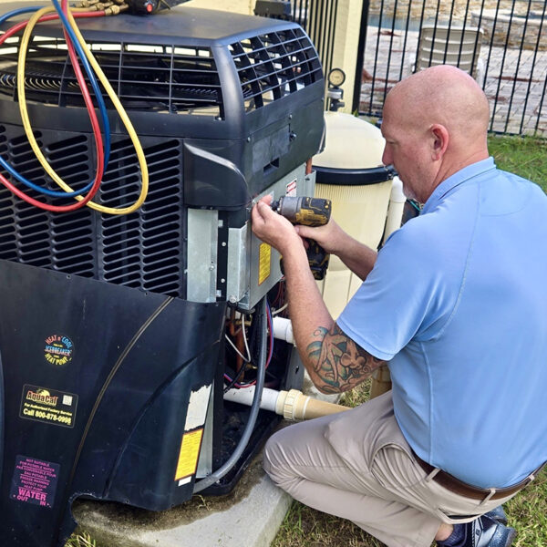 Davis Bros. Technician Working on Pool Heater